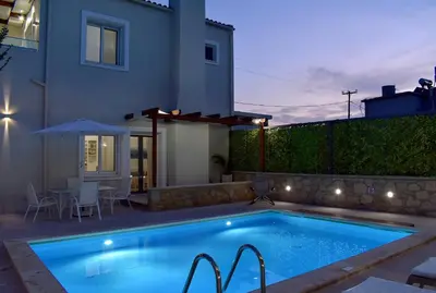 a swimming pool in front of a house at Villa Despina in Kisamos in Kissamos