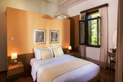 a bedroom with a large bed and a window at Villa Filoxenia 1937 in Gerani Chanion
