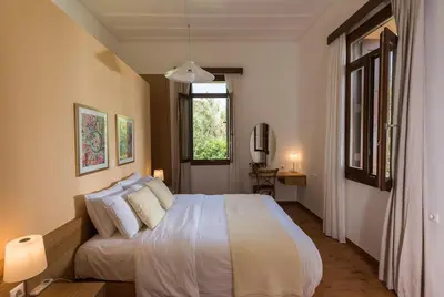 a bedroom with a bed and a window at Villa Filoxenia 1937 in Gerani Chanion