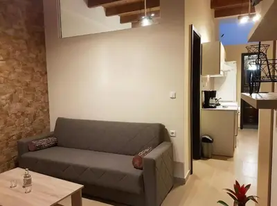 a living room with a couch and a table at Agora Apartments Ground Floor in Kissamos