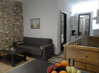 a living room with a couch and a bowl of fruit at Agora Apartment First Floor in Kissamos