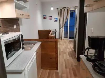 a kitchen with a white stove top oven next to a counter at Agora Apartment First Floor in Kissamos