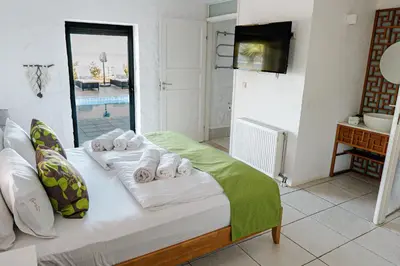 a bedroom with a bed with towels on it at Yellow Dream Villas in Chorafakia