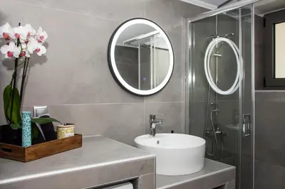 a bathroom with a sink and a mirror at Christina Apartment in Kissamos