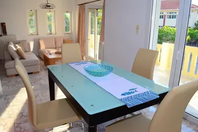 a dining room with a blue table and chairs at Christina Apartment in Kissamos