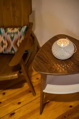 a wooden table with a plate on it next to a chair at Casa Irene in Chania Town