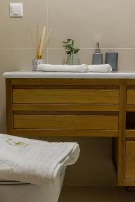a wooden dresser with two towels on top of it at Casa Irene in Chania Town