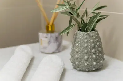 a white table with a vase with a plant in it at Casa Irene in Chania Town