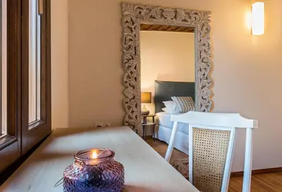 a living room with a table and a mirror at Casa Irene in Chania Town