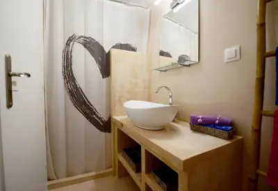 a bathroom with a white sink and a shower at Traditional Cretan Country House (9klm from Elafonissi) in Plokamianá