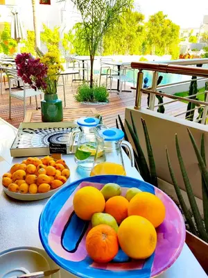 a plate of oranges and limes on a table at Libyan Princess in Palaiochóra