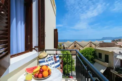 a bowl of fruit on a table on a balcony at Diamond Luxury Suites in Chania Town