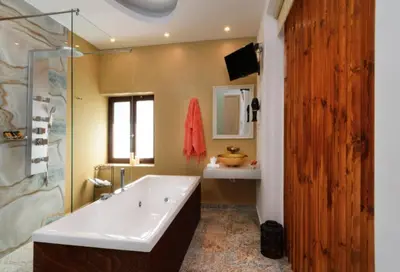 a bathroom with a tub and a sink at Diamond Luxury Suites in Chania Town