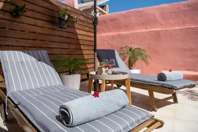 two chairs sitting on a patio with a table at Viaggio Elegant Rooms in Chania Town