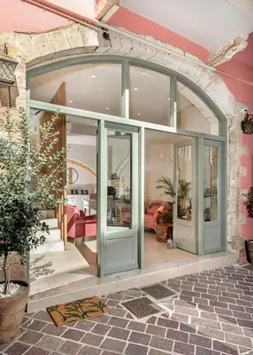 an open glass door in a house with a living room at Viaggio Elegant Rooms in Chania Town