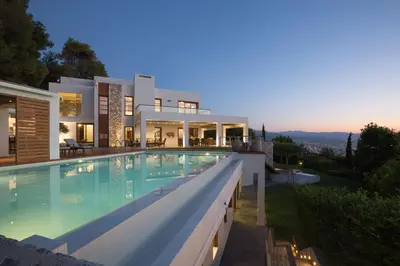 a villa with a swimming pool at dusk at VILLA TERRA CRETA Luxury Retreat and Spa in Chania Town