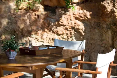 a wooden table with chairs and a wooden box on it at VILLA TERRA CRETA Luxury Retreat and Spa in Chania Town