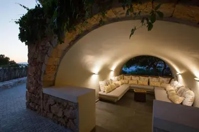a stone archway with a couch and a table at VILLA TERRA CRETA Luxury Retreat and Spa in Chania Town