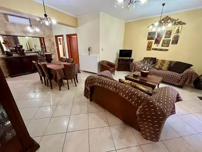 a living room with a couch and a table at Rosmarino in Kissamos