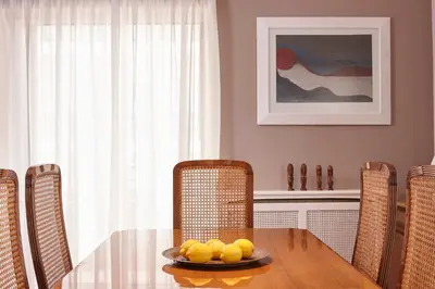 a dining room table with a plate of fruit on it at La Vita Classica in Chania Town