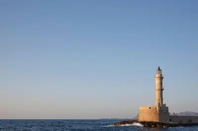a lighthouse on a small island in the water at La Vita Classica in Chania Town