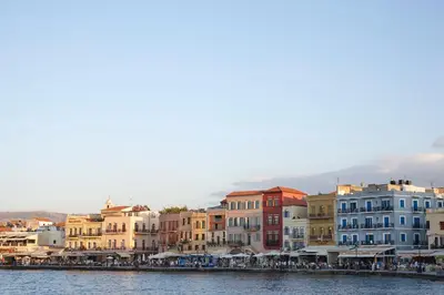 a group of buildings next to a body of water at La Vita Classica in Chania Town