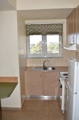 a small kitchen with a sink and a window at Studios Staring at the Sunset in Chania Town