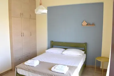a bedroom with a bed with two towels on it at Studios Staring at the Sunset in Chania Town