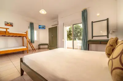 a bedroom with a large bed and a window at Akti Galinis in Kalyves