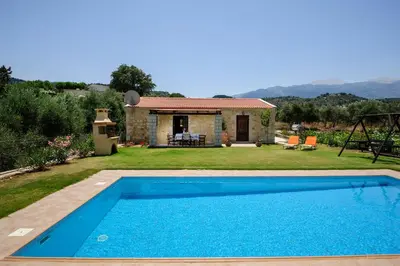 a villa with a swimming pool and a house at Kontis Village in Fílippos