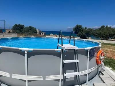 a small swimming pool with a boat next to it at Seaside Villa Balos in Kissamos