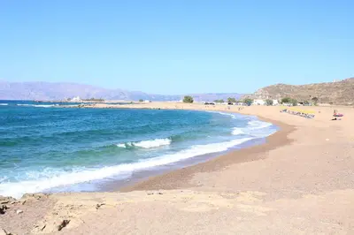 a beach with a bunch of people and the ocean at Seaside Villa Balos in Kissamos