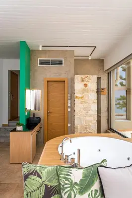 a bathroom with a bath tub in a room at Kalamaki Luxury Suites in Kalamaki Chanion