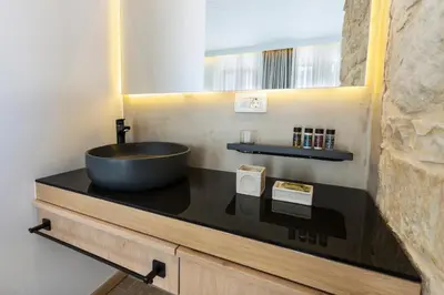 a bathroom with a bowl sink on a counter at Kalamaki Luxury Suites in Kalamaki Chanion