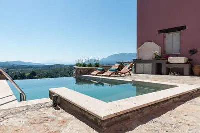 a swimming pool in the middle of a house at Listen to Nature in a Renovated Traditional Hilltop Villa Liodosifis with Heated Pool in Païdhokhórion