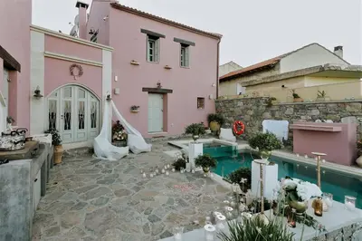 a courtyard of a house with a swimming pool at Listen to Nature in a Renovated Traditional Hilltop Villa Liodosifis with Heated Pool in Païdhokhórion