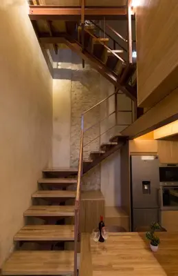 a staircase in a kitchen with wine glasses on a table at Evans House II in Chania Town