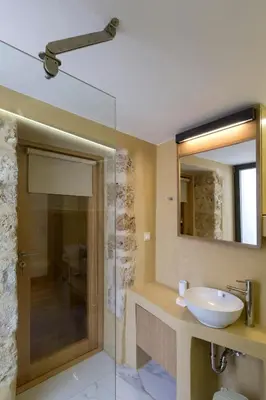 a bathroom with a sink and a mirror at Evans House II in Chania Town