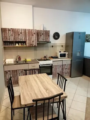 a kitchen with a table and chairs and a refrigerator at Beach House in Kissamos