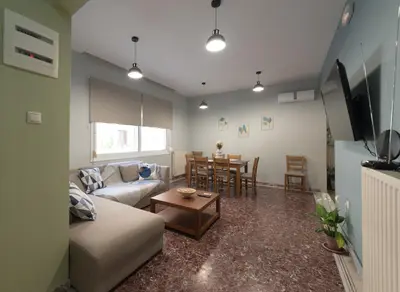 a living room with a couch and a table at Cityscape House in Chania Town