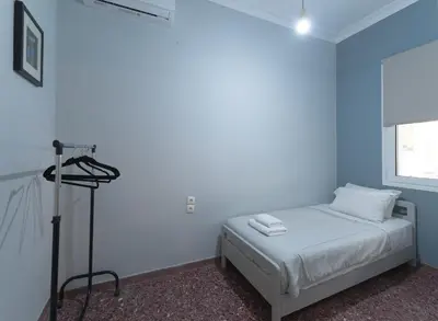 a bedroom with blue walls and a bed with a camera at Cityscape House in Chania Town