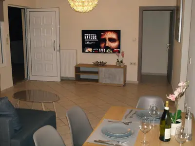 a living room with a table and a tv at Urban Sea Apts in Chania Town