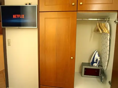 a closet with a wooden door in a room at Urban Sea Apts in Chania Town