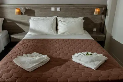 a bedroom with a bed with two towels on it at Anna Katerina Apartments in Plataniás