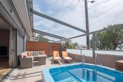 a balcony with a swimming pool and a patio furniture at UTOPIA luxury apartment in Chania Town