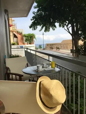 a straw hat sitting on a balcony with a table at Art Home in Chania Town