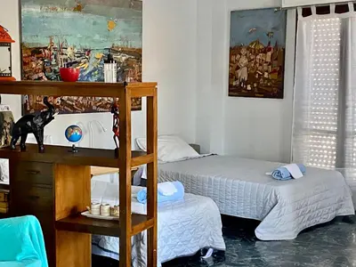 a bedroom with two beds and a shelf at Art Home in Chania Town