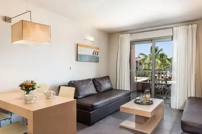 a living room with a couch and a table at Stellina Village in Kato Daratso