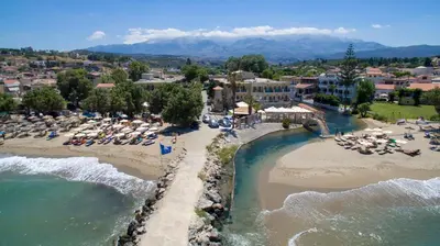 an aerial view of a beach with chairs and umbrellas at Kalyves Beach Hotel in Kalyves