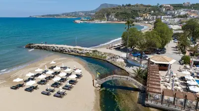 an aerial view of a beach with cars parked at Kalyves Beach Hotel in Kalyves